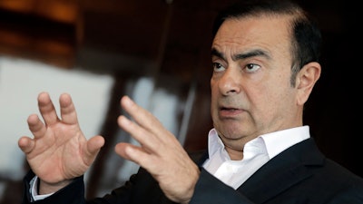 In this Friday, April 20, 2018 photo, Nissan Chairman Carlos Ghosn speaks during an interview in Hong Kong.