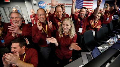 Engineers celebrate as the InSight lander touch downs on Mars at NASA's Jet Propulsion Laboratory.