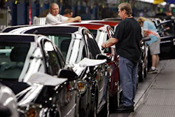 In this Tuesday, June 15, 2010, file photo, workers at General Motors' Lordstown Assembly plant put the final touches on Chevy Cobalts.