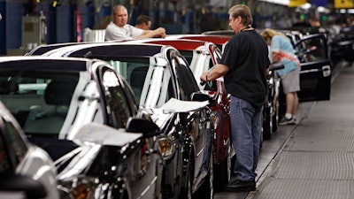 In this Tuesday, June 15, 2010, file photo, workers at General Motors' Lordstown Assembly plant put the final touches on Chevy Cobalts.