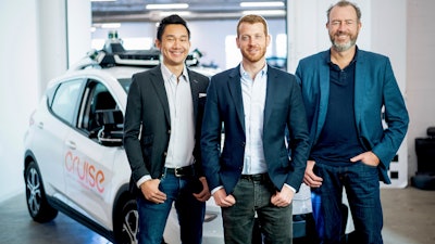In this Nov. 20, 2018, Cruise Automation's Dan Kan and Kyle Vogt pose for a photo with General Motors' Dan Ammann at Cruise Automation offices in San Francisco.