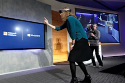In this Jan. 21, 2015, file photo, Microsoft's Lorraine Bardeen demonstrates the HoloLens headset at the company's headquarters in Redmond, Wash.