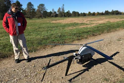 In this Oct. 17, 2017 photo, Nick Brown, a drone pilot for Pulse Aerospace of Lawrence, Kan., stands beside a Pulse Vapor unmanned aircraft at Griffiss International Airport in Rome, N.Y.