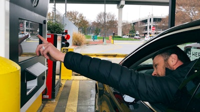 In this Friday, Dec. 7, 2018, photo, a driver demonstrates a new biometric scanning machine at Hartsfield-Jackson Atlanta International Airport.