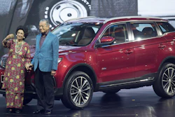 Malaysia Prime Minister Mahathir Mohamad, right, poses with his wife Siti Hasmah during the launch of Proton's new SUV in Kuala Lumpur.