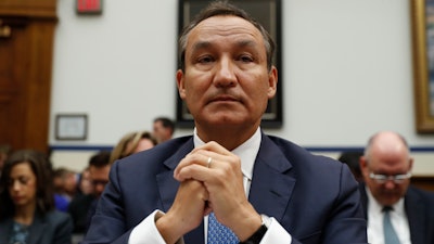In this May 2, 2017 file photo, United Airlines CEO Oscar Munoz prepares to testify on Capitol Hill in Washington.