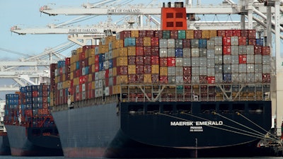 In this Thursday, July 12, 2018, file photo, the container ship Maersk Emerald is unloaded at the Port of Oakland, Calif.