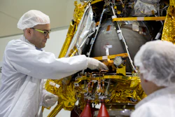 Yonatan Winetraub inserts a time capsule into the SpaceIL lunar module during a press tour of their facility near Tel Aviv, Monday, Dec. 17, 2018.