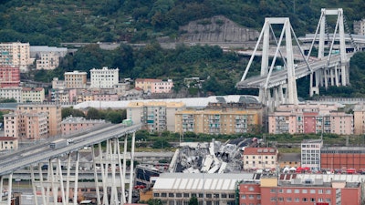 In this Tuesday, Aug. 14, 2018 file photo cars are blocked on the Morandi highway bridge after a section of it collapsed, in Genoa, northern Italy.