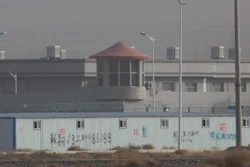 In this Monday, Dec. 3, 2018, photo, a guard tower and barbed wire fences are seen around a facility in the Kunshan Industrial Park in western China's Xinjiang region.