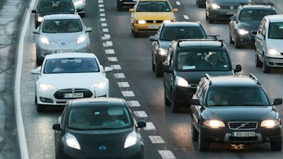 In this Nov. 26, 2014 file photo electric cars queue in the bus lane, left, on the main road into Oslo, Norway.