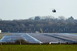 A police helicopter flies over the runway at Gatwick airport, London.