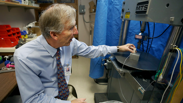 In this Dec. 17, 2018 photo, John Szivek of the University of Arizona explains how the scaffold made from a 3-D printer is tested.