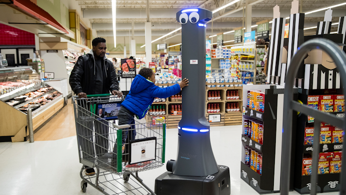 William Rucker and his grandson Justice, 4, say hello to a robot named Marty as it cleans the floors at a Giant grocery store in Harrisburg, Pa., Tuesday, Jan. 15, 2019.