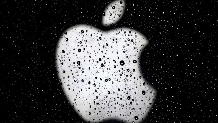 In this Dec. 26, 2018, file photo, an Apple logo on a window at the Country Club Plaza shopping district in Kansas City, Mo.