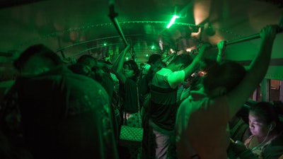 People stand in a bus as they wait to go home after their work day at a 'maquiladora' in Matamoros, Tamaulipas state, Mexico, Wednesday, March, 22, 2017.