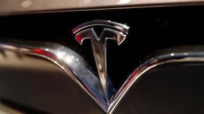 This Oct. 3, 2018, file photo shows a Tesla emblem at the Auto show in Paris.