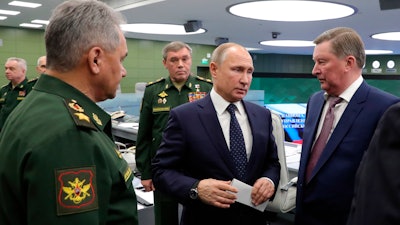 Defense Minister Sergei Shoigu, left, and President Vladimir Putin oversee the test launch of the Avangard hypersonic glide vehicle from Moscow.