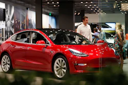 In this July 6, 2018, file photo, a Model 3 sits on display in a Tesla showroom in the Cherry Creek Mall in Denver.