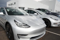 In this July 8, 2018, photo 2018 Model 3 sedans sit on display outside a Tesla showroom in Littleton, Colo.