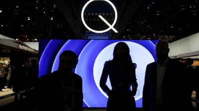 In this Jan. 6, 2017, file photo attendees stand in front of a QLED TV at the Samsung booth during CES International in Las Vegas.