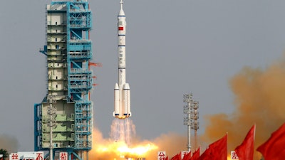 In this file photo taken Saturday, June 16, 2012, a Shenzhou 9 spacecraft Long March rocket launches from the Jiuquan Satellite Launch Center.