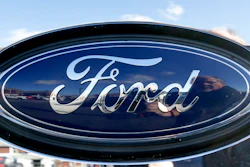 This Nov. 19, 2015 file photo shows the blue Ford oval badge in the grill of a pickup truck on the sales lot at Butler County Ford in Butler, Pa.