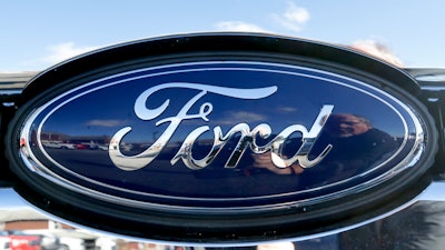 This Nov. 19, 2015 file photo shows the blue Ford oval badge in the grill of a pickup truck on the sales lot at Butler County Ford in Butler, Pa.