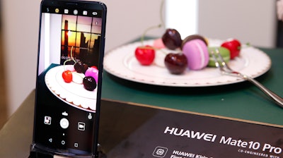 In this Jan. 6, 2018, file photo the Huawei Mate10 Pro phone is displayed at the Huawei booth during CES International in Las Vegas.