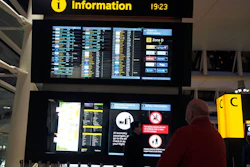 Passengers look at the departure board after planes were temporarily suspended at Heathrow Airport in London, Tuesday, Jan. 8, 2019.