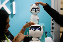 People touch Kiki robots at the Zoetic AI booth at CES International, Wednesday, Jan. 9, 2019, in Las Vegas.