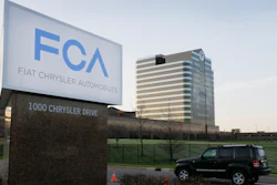 In this May 6, 2014, file photo, a vehicle moves past a sign outside Fiat Chrysler Automobiles world headquarters in Auburn Hills, Mich.
