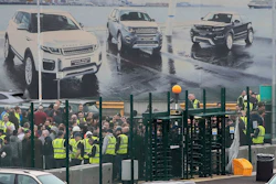 Staff gather inside the gates of the Jaguar Land Rover site in Halewood near Liverpool, England, Thursday Jan. 10, 2019.