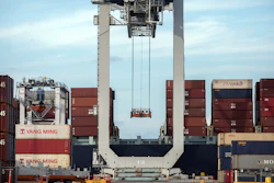 In this July, 5, 2018, file photo, a ship to shore crane prepares to load a 40-foot shipping container onto a container ship in Savannah, Ga.