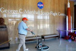 A worker cleans the floors at NASA's Marshall Space Flight Center in Huntsville, Ala., Wednesday, Jan. 9, 2019.