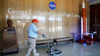 A worker cleans the floors at NASA's Marshall Space Flight Center in Huntsville, Ala., Wednesday, Jan. 9, 2019.