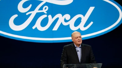 In this Jan. 14, 2018, file photo Ford President and CEO Jim Hackett prepares to address the media at the North American International Auto Show in Detroit.