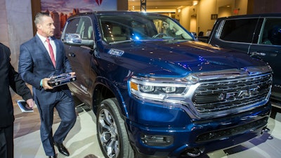 Reid Bigland, head of the Ram brand, walks next to the Ram 1500 pickup truck after it was awarded the 2019 North American Truck of the Year, Monday, Jan. 14, 2019.