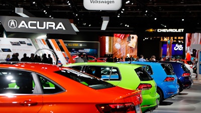 Signage for automakers Volkswagen, Acura, Chevrolet and Ford, Tuesday, Jan. 15, 2019, at the North American International Auto Show in Detroit.