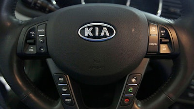 This Oct. 5, 2012, file photo shows a Kia optima's steering wheel inside of a Kia car dealership in Elmhurst, Ill.