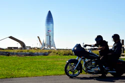 In this Jan. 12, 2019 file photo, a motorcyclist rides near the SpaceX prototype Starship hopper at the Boca Chica Beach site in Texas.