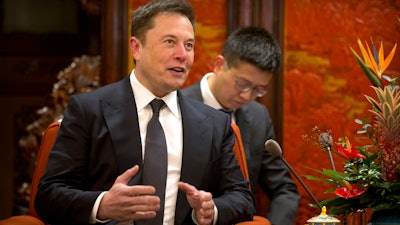 In this Jan. 9, 2019, file photo, Tesla CEO Elon Musk speaks during a meeting with Chinese Premier Li Keqiang at the Zhongnanhai leadership compound in Beijing.