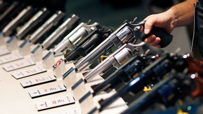 In this Jan. 19, 2016 file photo, handguns are displayed at the Smith & Wesson booth at the Shooting, Hunting and Outdoor Trade Show in Las Vegas.
