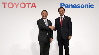 In this Dec. 13, 2017, file photo, Toyota President Akio Toyoda and Panasonic President Kazuhiro Tsuga pose after a press conference in Tokyo.