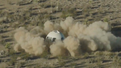 In this image from video made available by Blue Origin, the New Shepard capsule lands at the company's site in west Texas.