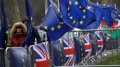 Flags tied to railings outside parliament in London, Thursday, Jan. 24, 2019.