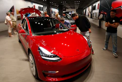 In this July 6, 2018, file photo, a Model 3 sits on display in a Tesla showroom in the Cherry Creek Mall in Denver.