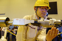 Toshiba Corp.'s energy systems unit group manager Jun Suzuki shows a remote-controlled melted fuel probe device at its facility in Yokohama, Monday, Jan. 28, 2019.