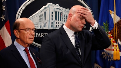 Acting Attorney General Matt Whitaker wipes his brow after announcing an indictment of Chinese telecommunications companies, Monday, Jan. 28, 2019.
