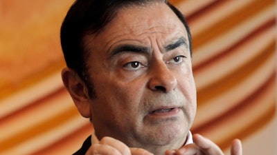 In this April 20, 2018, file photo, then-Nissan Chairman Carlos Ghosn speaks during an interview in Hong Kong.